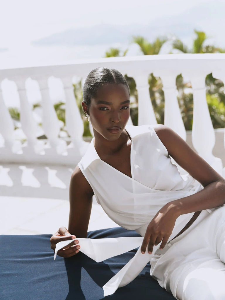 Model wearing an all white outfit featuring the Hutch valen top in white with side tie detail.