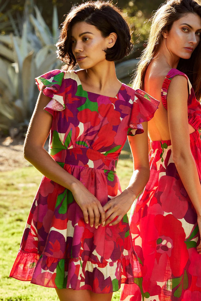 Models wearing MISA dresses with Flora rosanda print outside 