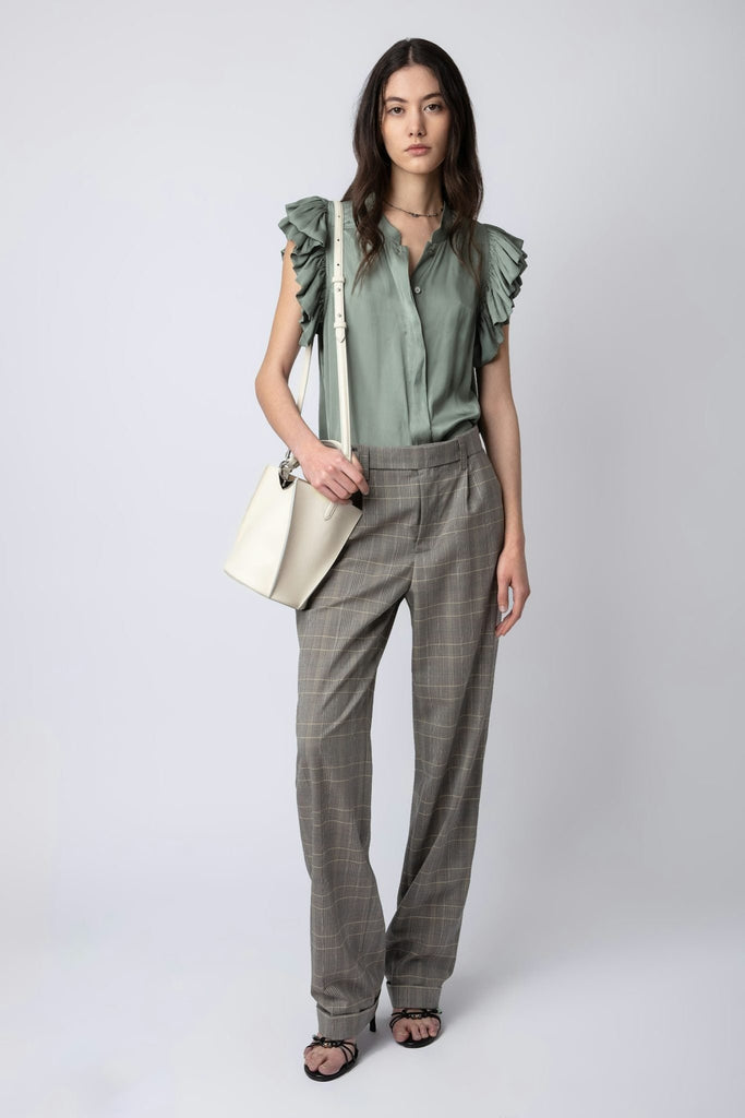Model wearing the zadig and voltaire tiza satin top in treillis with pants and crossbody bag