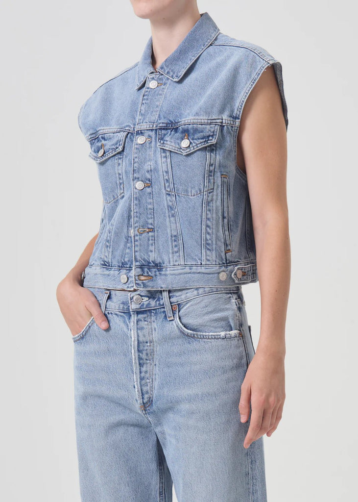 Agolde denim charli vest in immortal styled on model with light wash jeans.