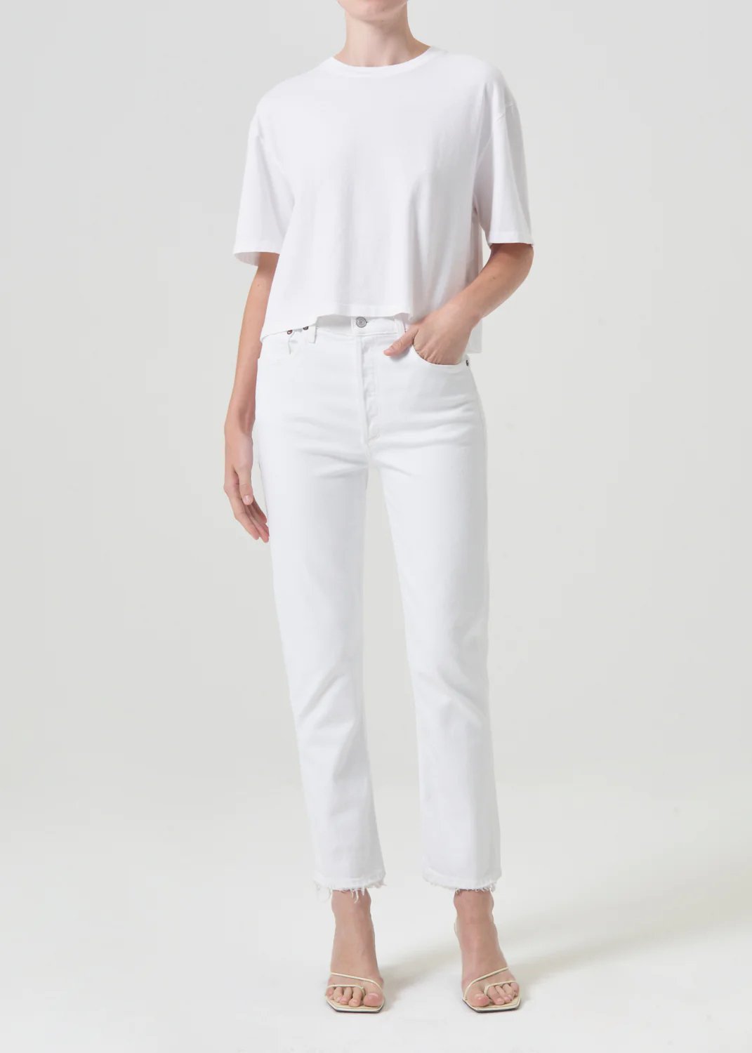 agolde women's riley high rise straight crop denim in sour cream. Model is wearing monochromatic outfit.