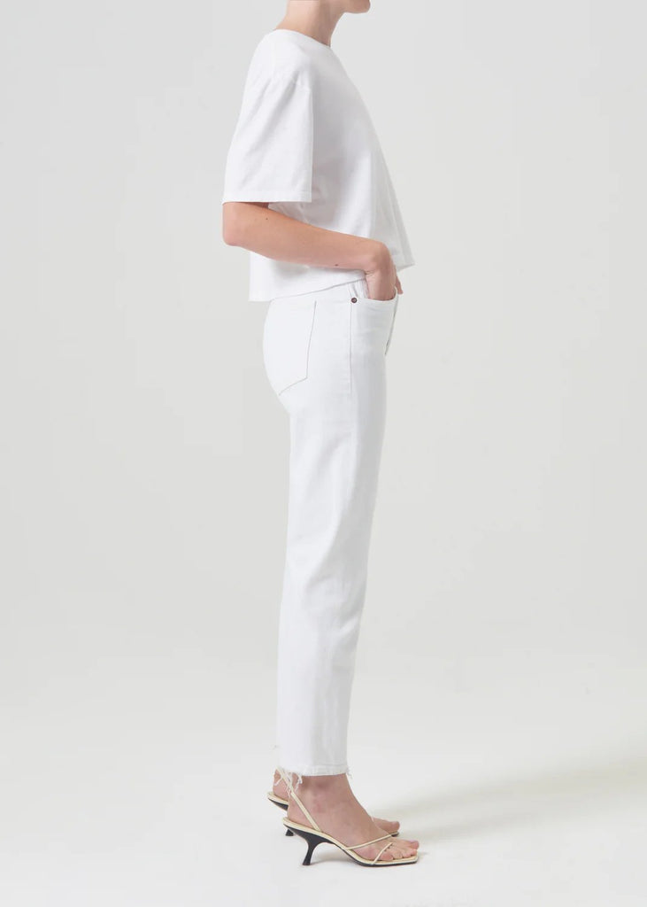 agolde women's riley high rise straight crop denim in sour cream. Model is wearing monochromatic outfit. Side view.