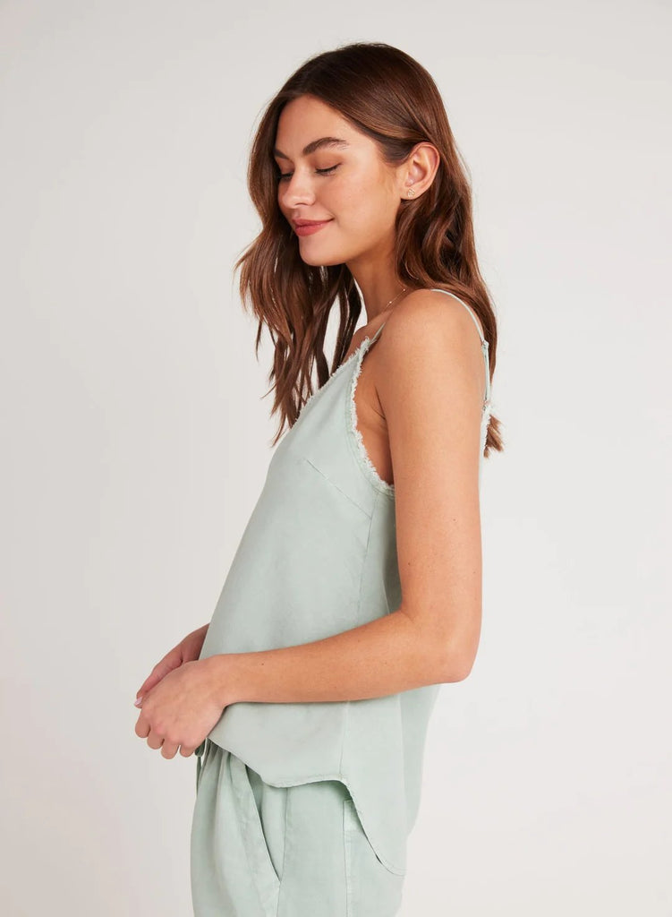 Side view of the bella dahl frayed cami in oasis green styled with matching shorts on model. 