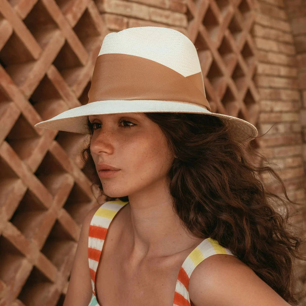 Women's freya gardenia hat in natural/tan on model. Brown fabric on natural/tan hat.
