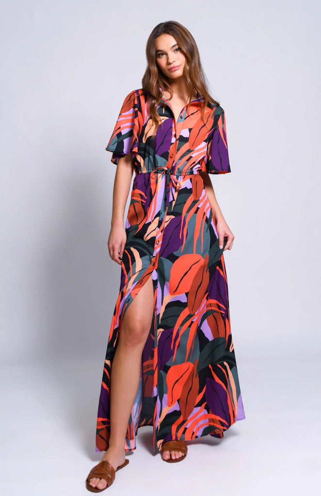 short sleeve hutch layton dress in multicolored tropical leaves with slit styled on model