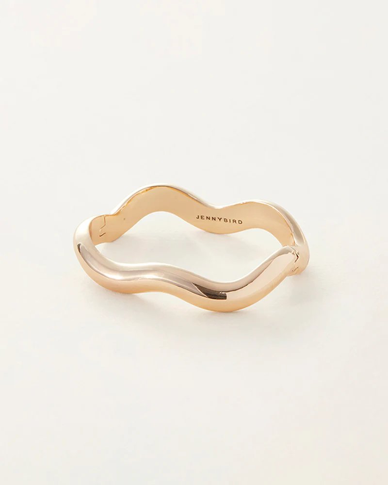 Jenny Bird Ola bangle in high polish gold. Curved gold bangle with a hinge and tab lock closure.