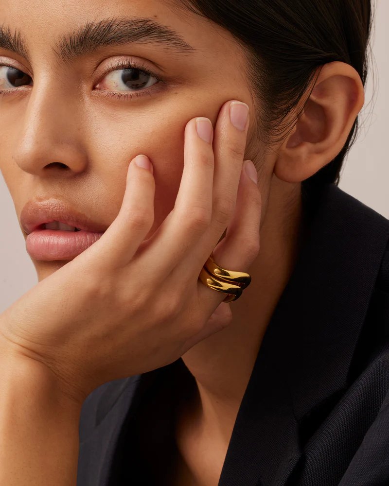 Jenny Bird ola ring set in high polish gold. Styled and stacked on model's finger.