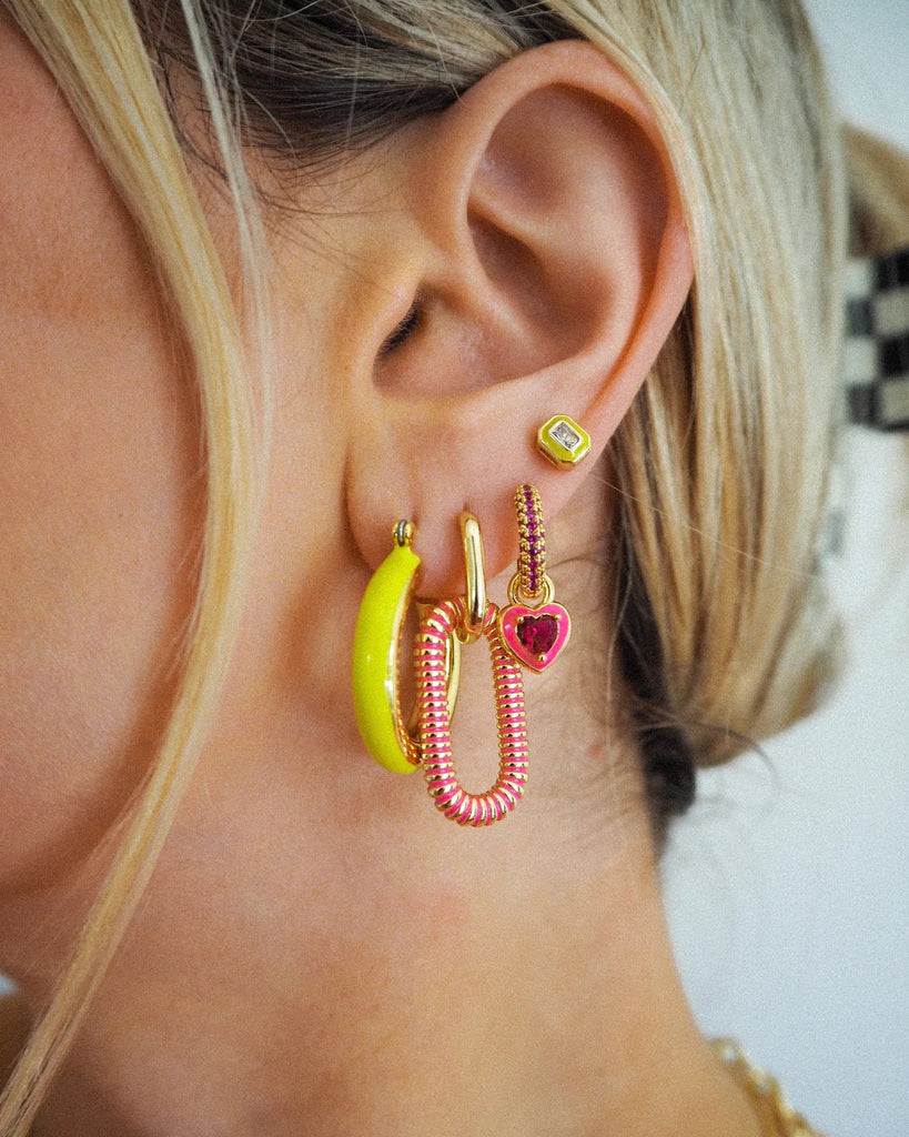 luv aj bezel studs in neon yellow and gold women's jewelry on model 