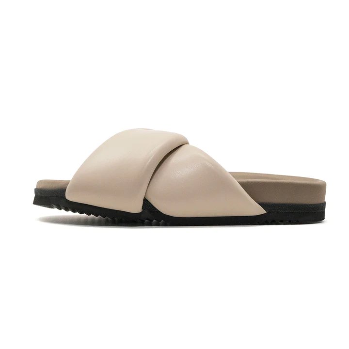 Roam women's foldy puffy sandals in cream, side view.