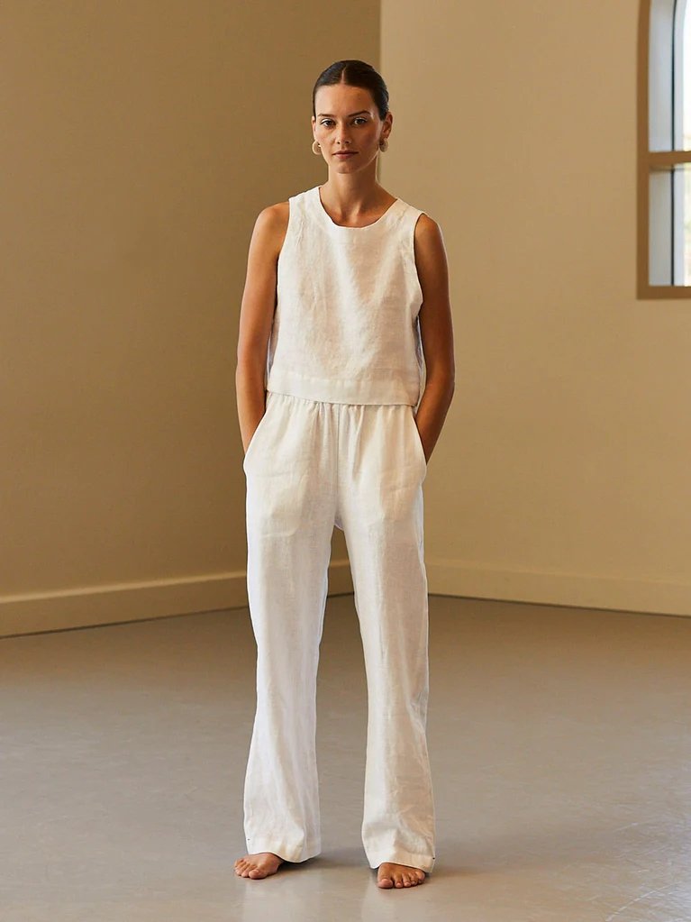 Model wearing the Xirena atticus pants in white with a matching top